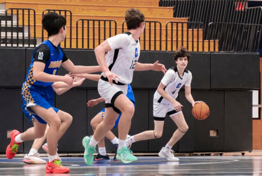 Centennial High School JV players in a game on the court